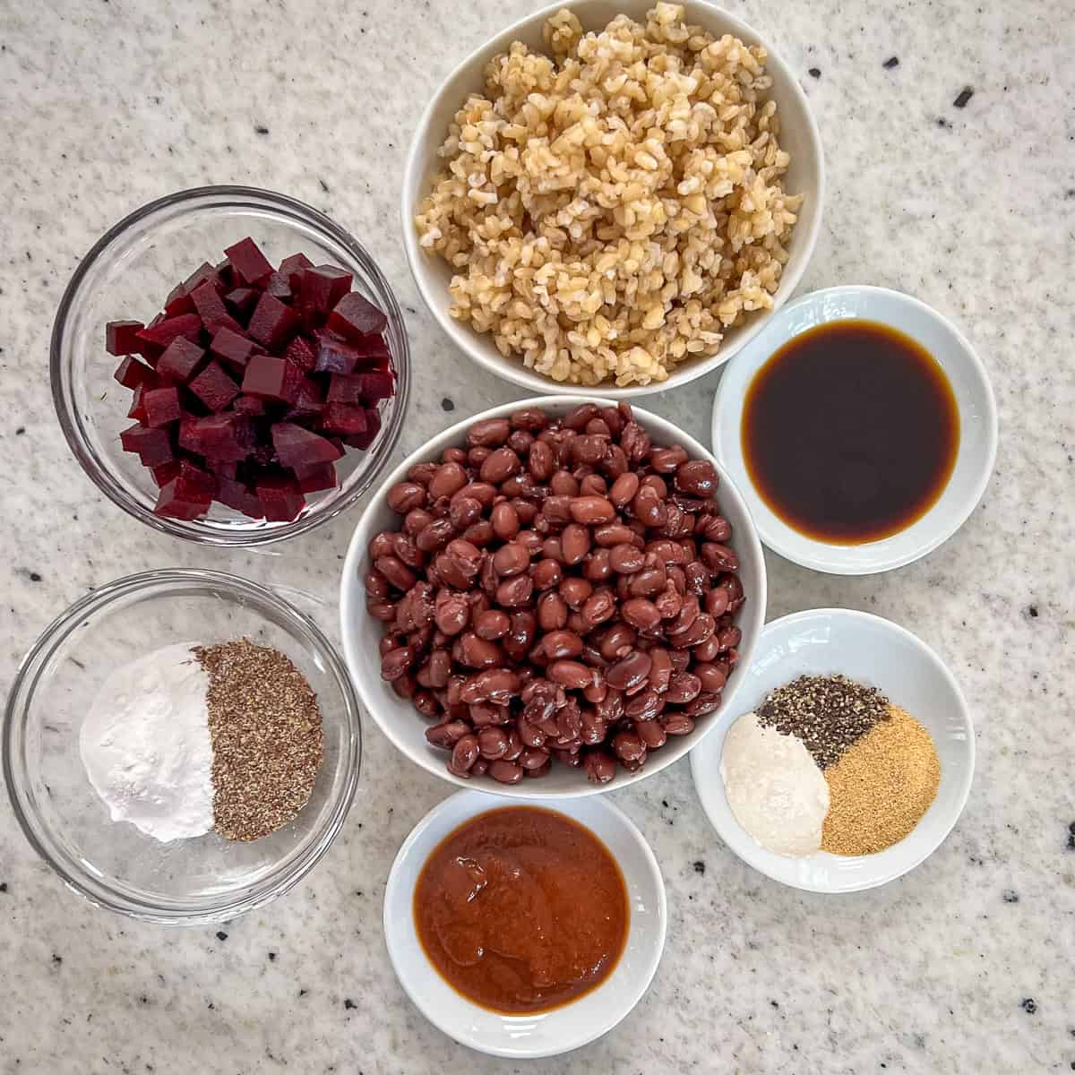 Ingredients for vegan sliders: black beans, cooked brown rice, cooked diced beet, BBQ sauce, and seasonings.