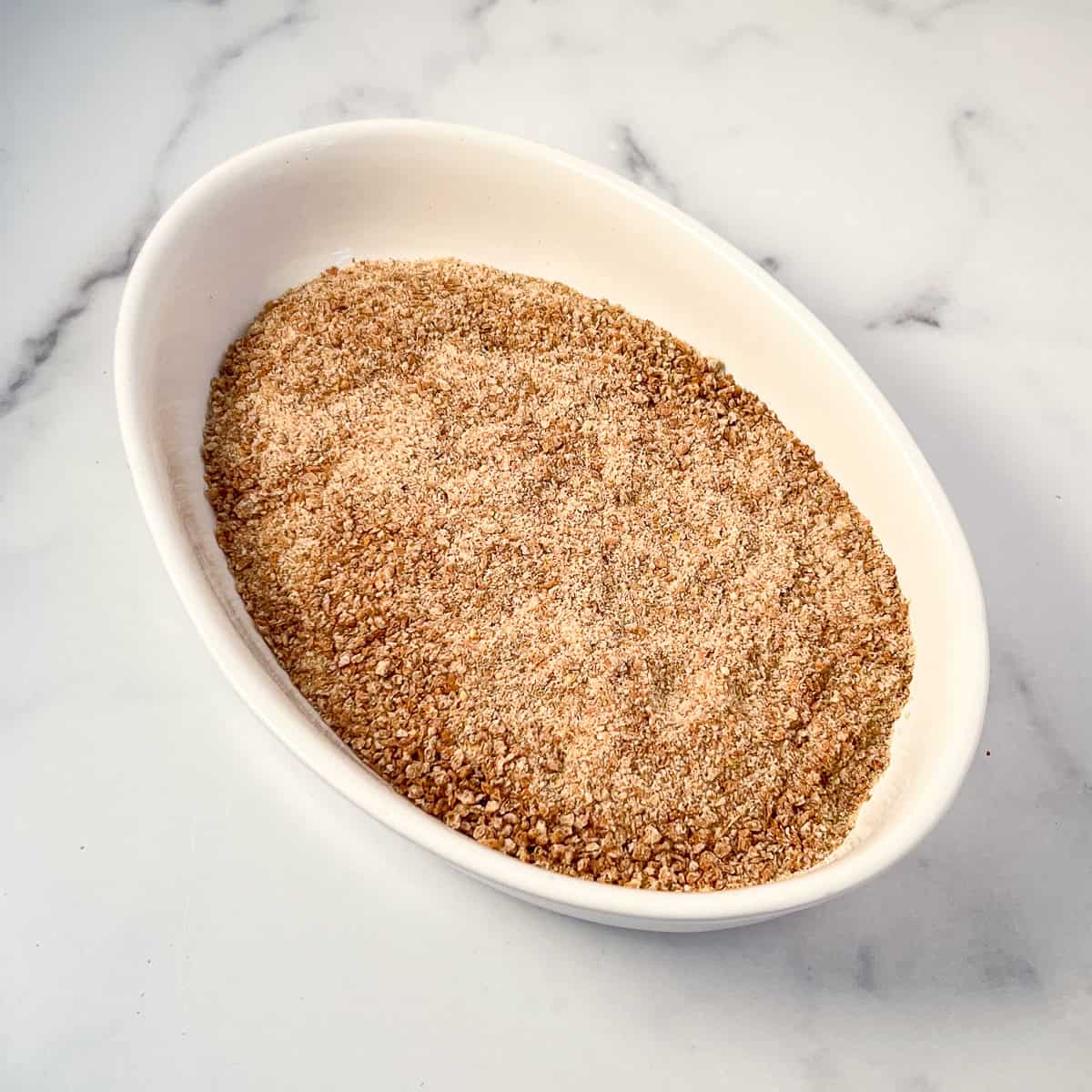 Whole grain bread crumbs in an oval dish.