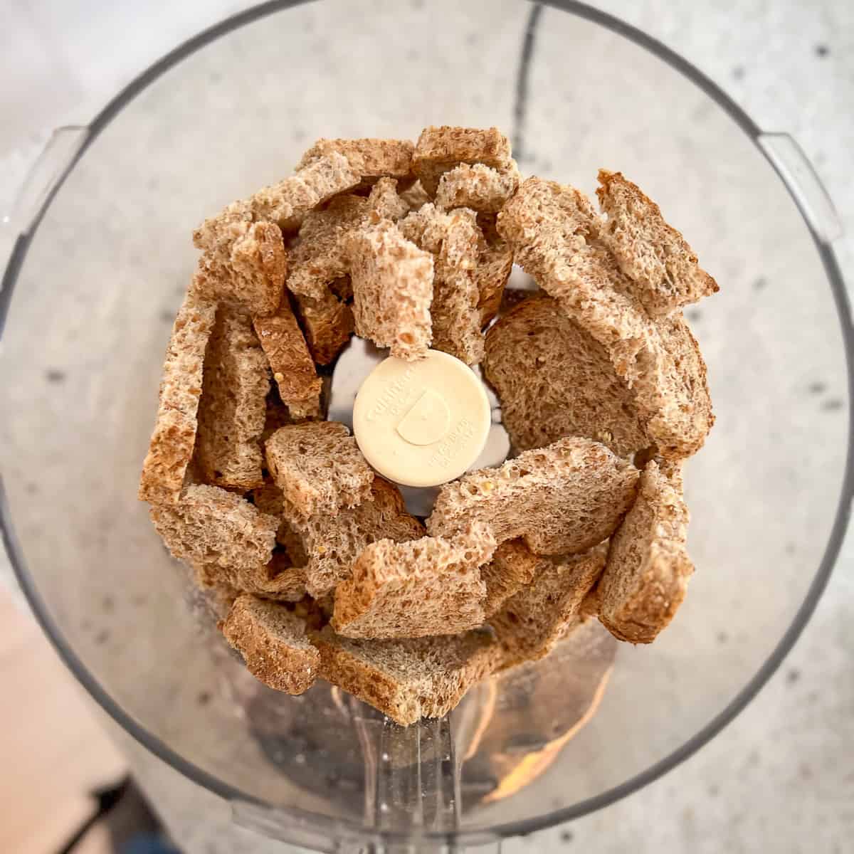 Chunks of bread in a food processor.