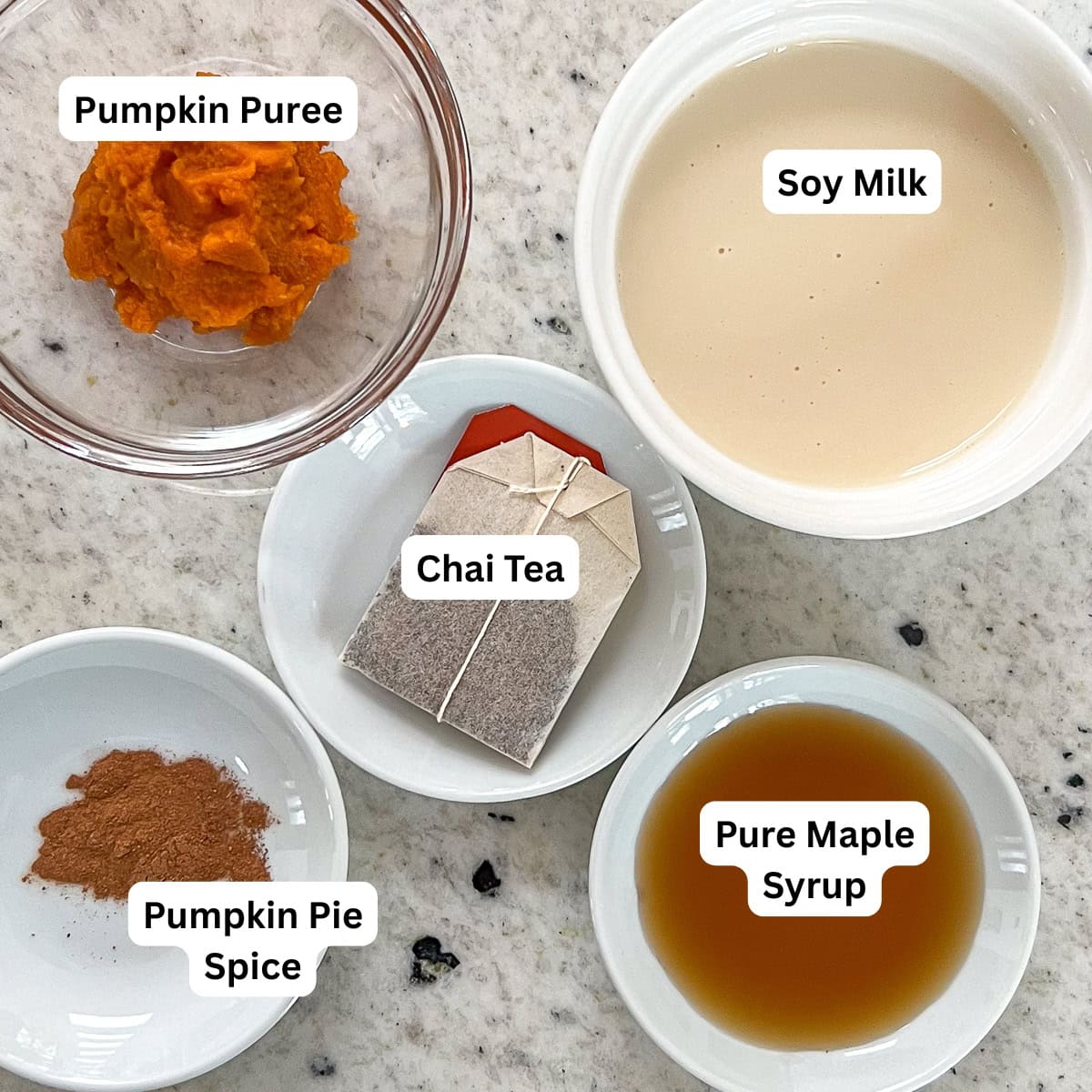 Ingredients for pumpkin spice chai latte: chia tea bag, soymilk, maple syrup, pumpkin pie spice, and pumpkin puree.