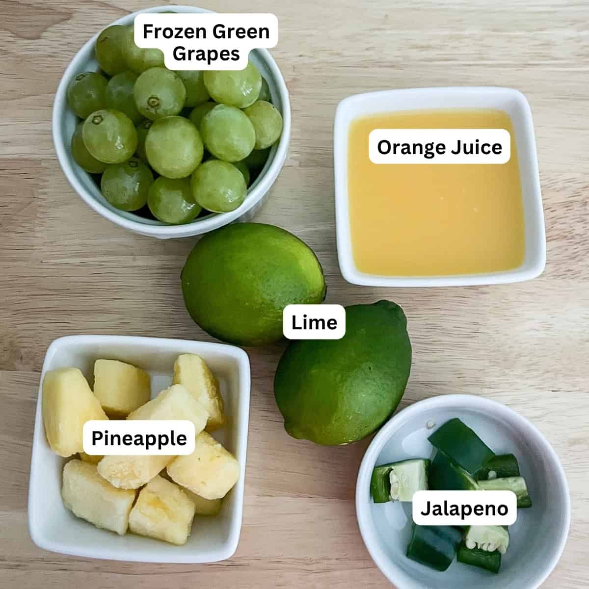 Ingredients for the mocktail: grapes, pineapple, lime juice, orange juice, and jalapeno.