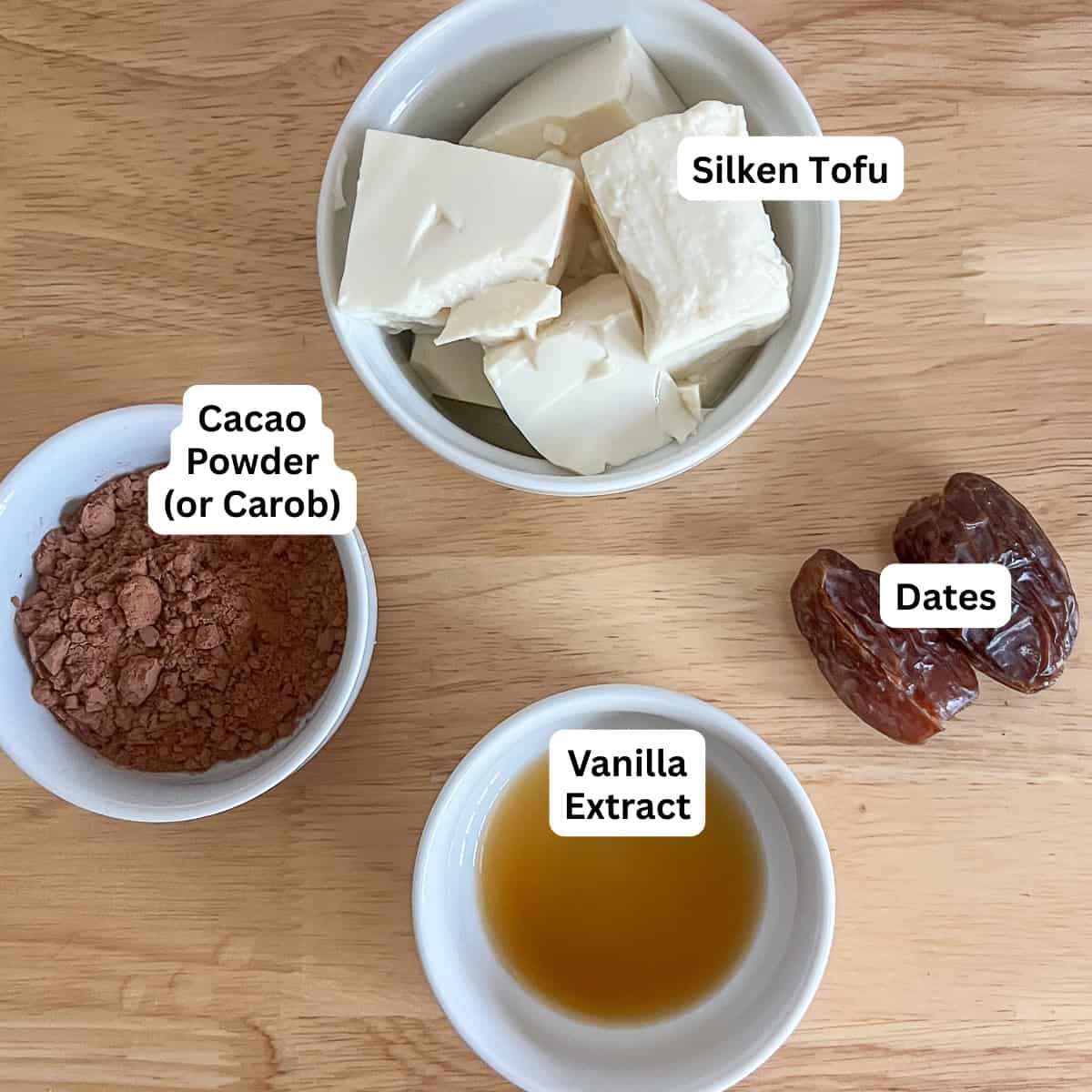 Ingredients for tofu chocolate mousse: silken tofu, cocoa powder, vanilla and dates.