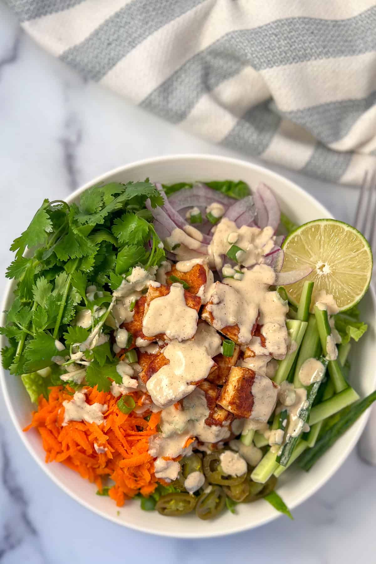 Vegan banh mi salad bowl with fresh veggies, lime and sauce. 