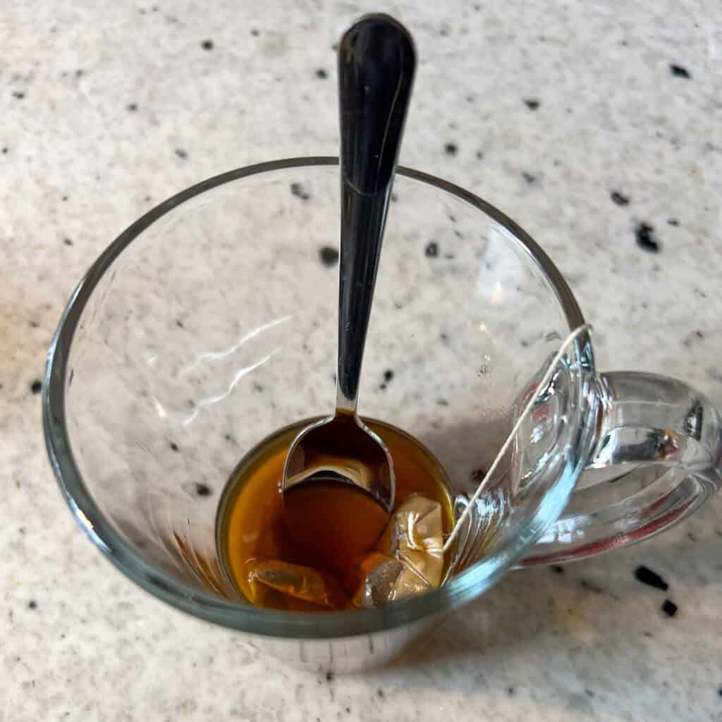 A mug with a chai tea bag steeping.
