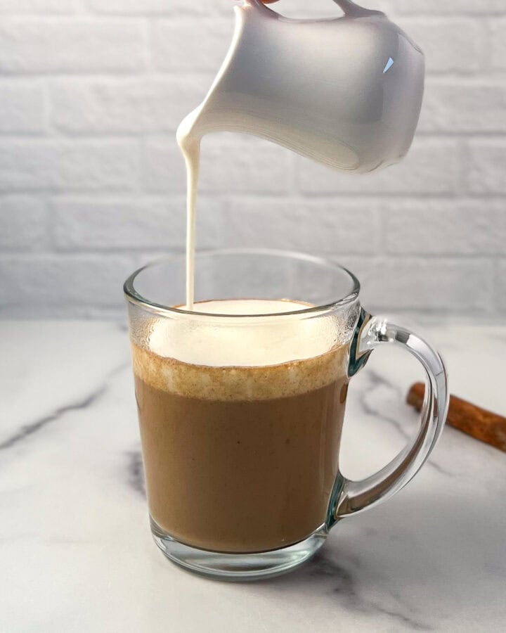 Frothed soymilk being added to the pumpkin spice chai latte.
