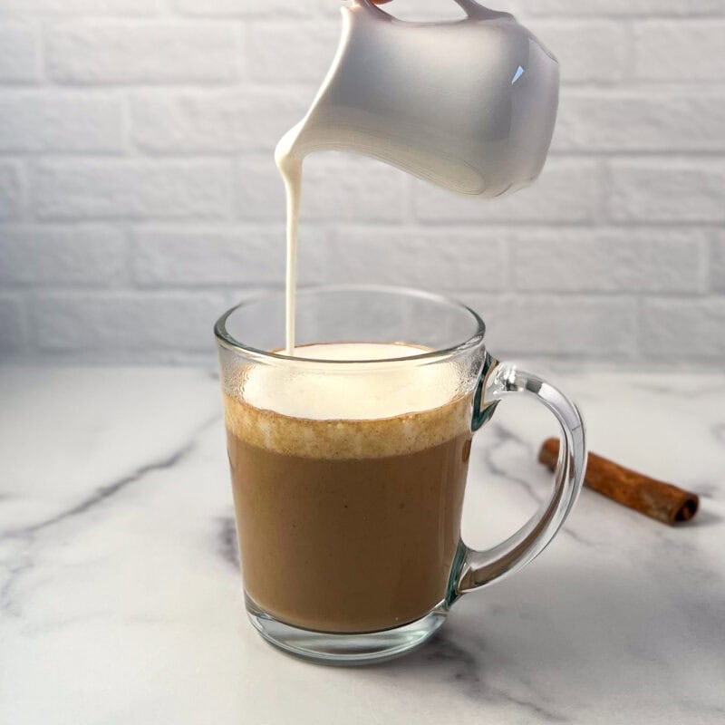 Frothed soymilk being added to the pumpkin spice chai latte.