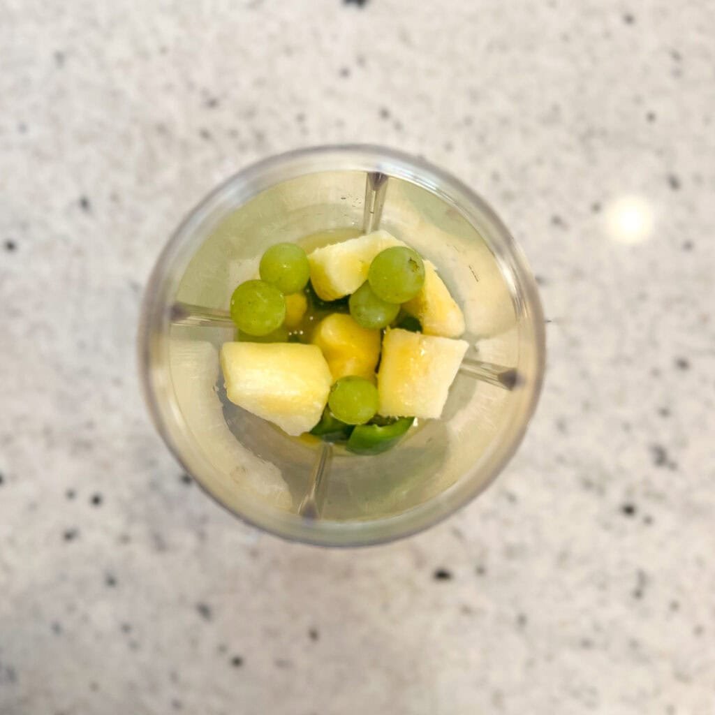 Ingredients for spicy margarita mocktail in a bullet blender cup before blending.
