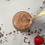 Top view of tofu chocolate mousse in a glass dish and spoon sticking out.