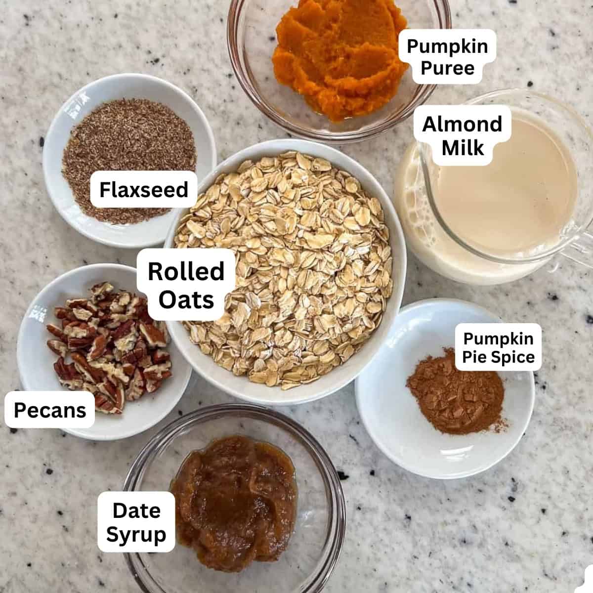 Ingredients, rolled oats, flaxseed, almond milk, pumpkin puree, pumpkin pie spice, and date syrup and pecans.