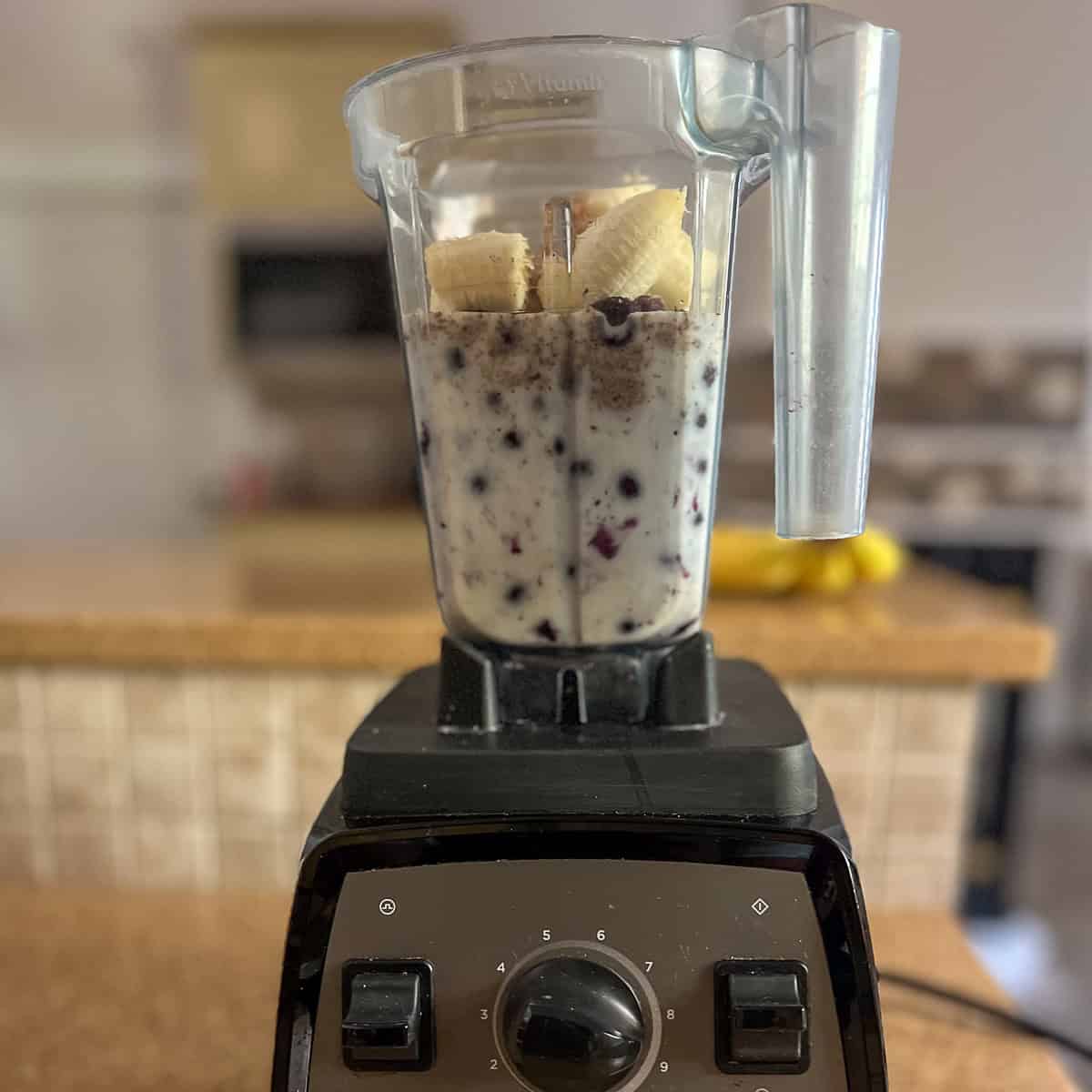 Blueberries, plant based milk, banana, ground flaxseeds and peanut butter in a blender.