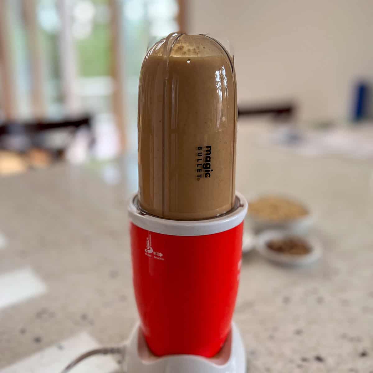 Pumpkin mixture being blended in a mini blender.