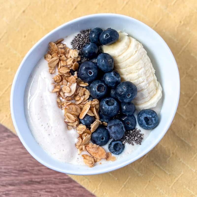 Soy yogurt with fresh fruit and granola in a bowl.