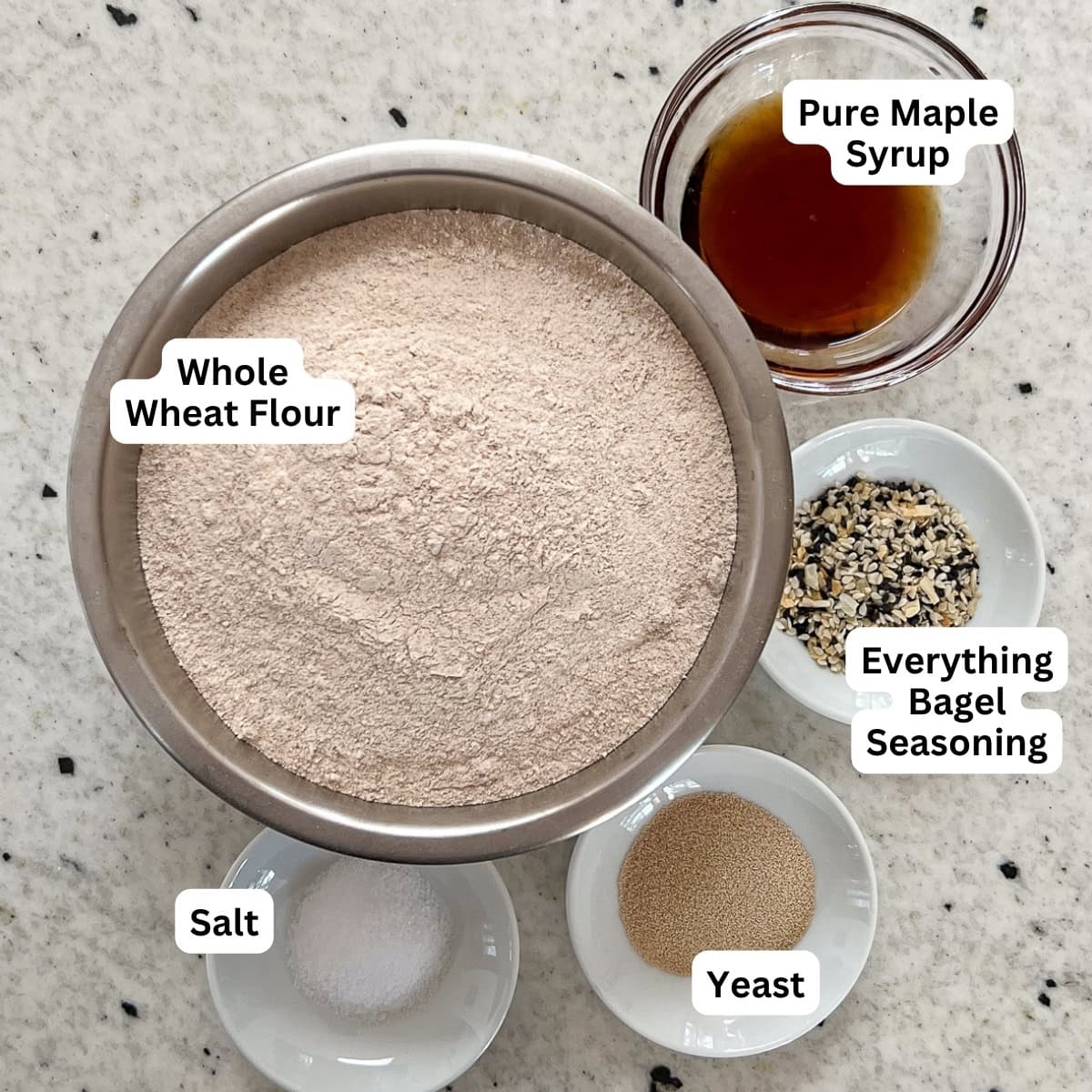 Ingredients for homemade whole wheat bagels: whole wheat flour, salt, yeast, maple syrup, everything bagel seasoning.