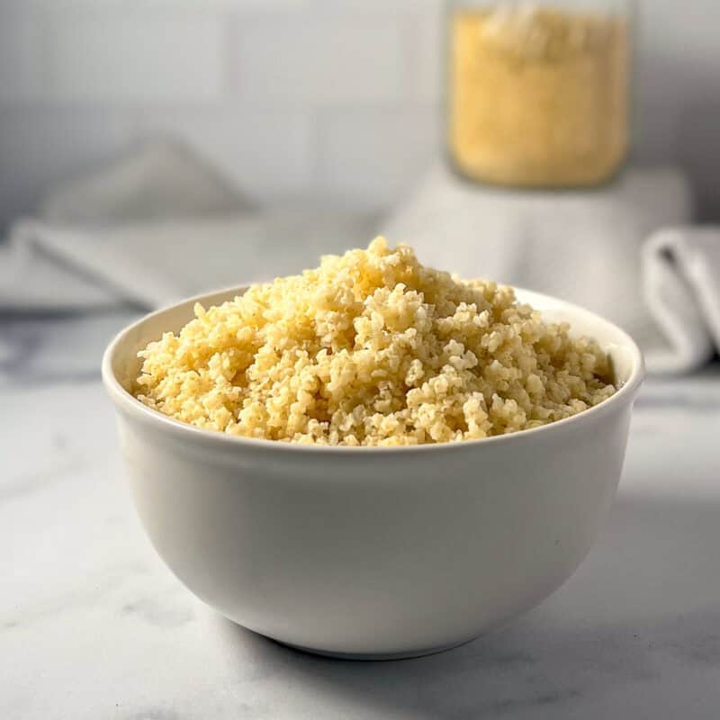 Side view of a bowl of cooked millet.