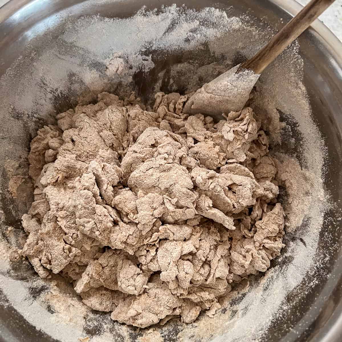 Shaggy dough in a mixing bowl.