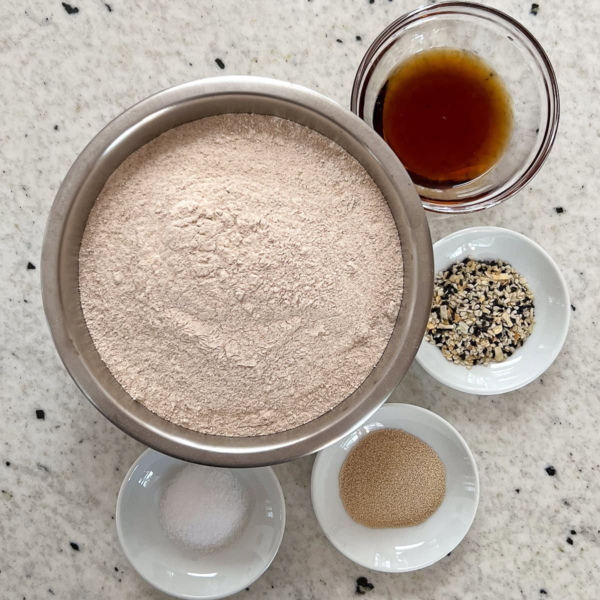 Ingredients for homemade whole wheat bagels: whole wheat flour, salt, yeast, maple syrup, everything bagel seasoning.