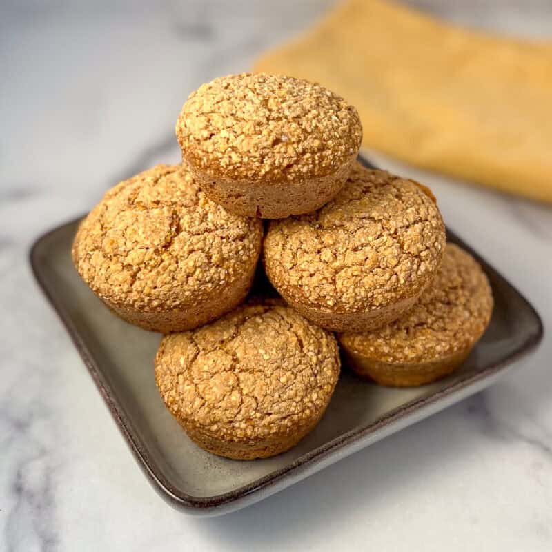 A stack of gluten free no oil vegan cornbread muffins.