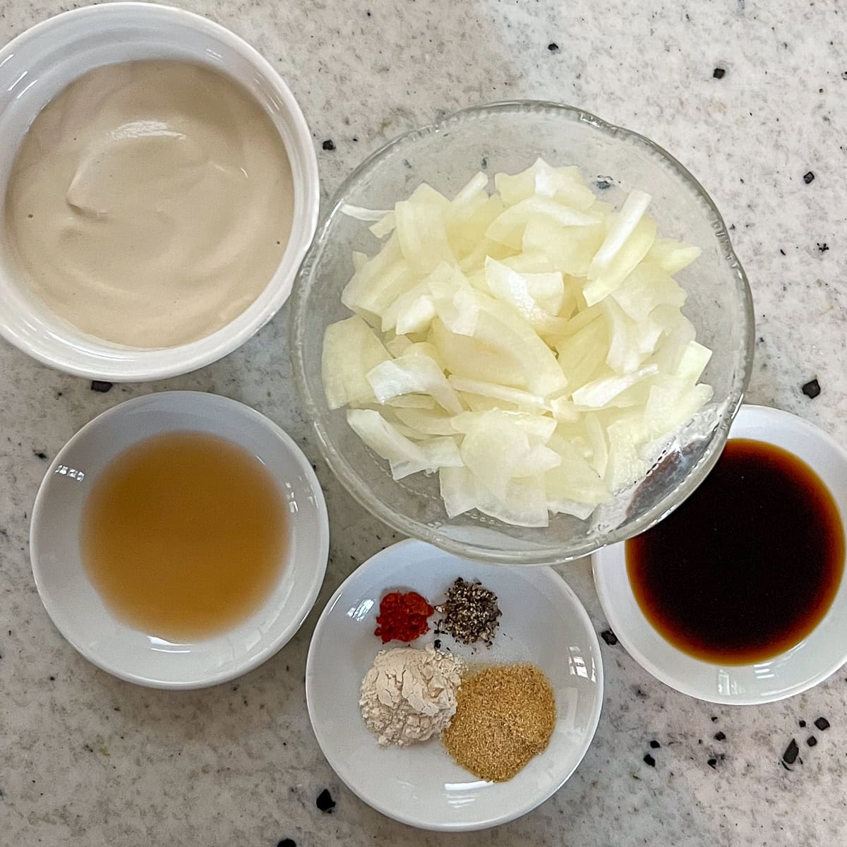 Ingredients for dairy free onion dip: onions, cashew sour cream, seasonings and spices.