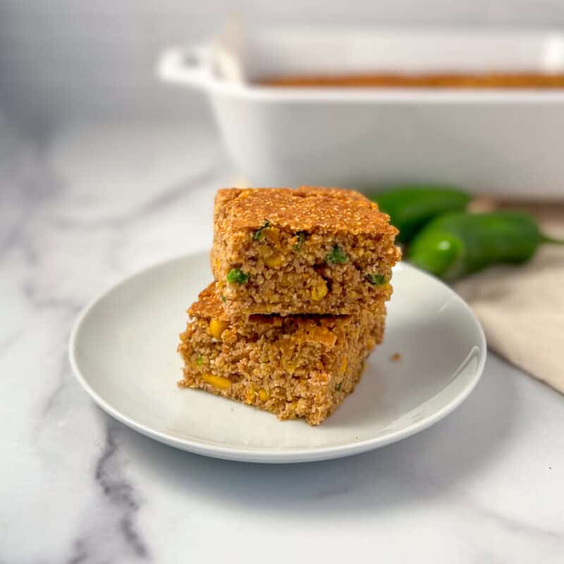 Two slices of vegan jalapeno cornbread on a plate.