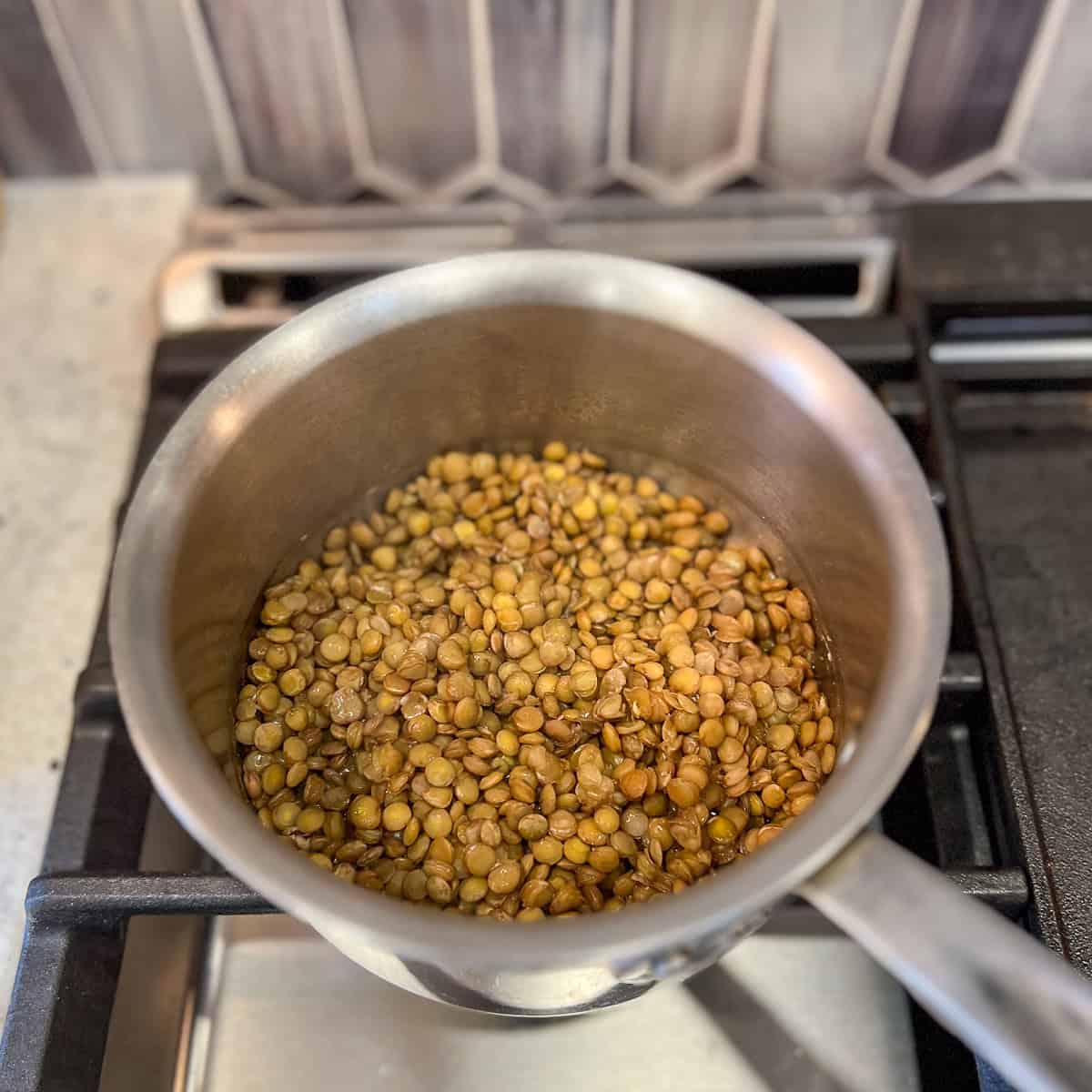 Cooked lentils in a pot on the stovetop.