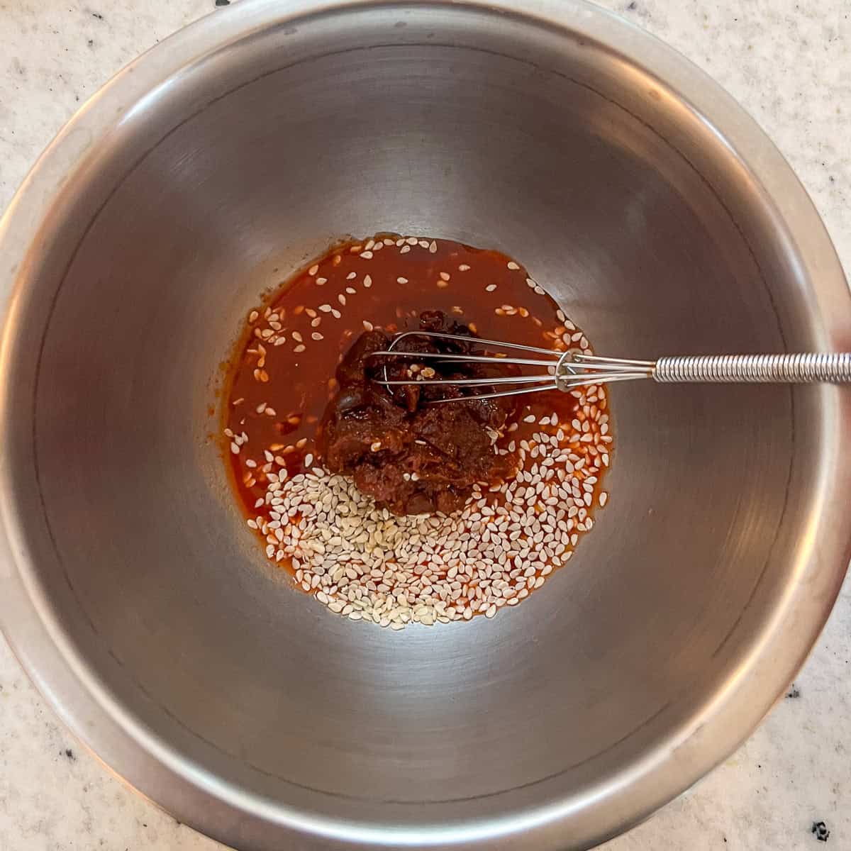 Kimchi fried rice sauce ingredients in a mixing bowl before mixing.