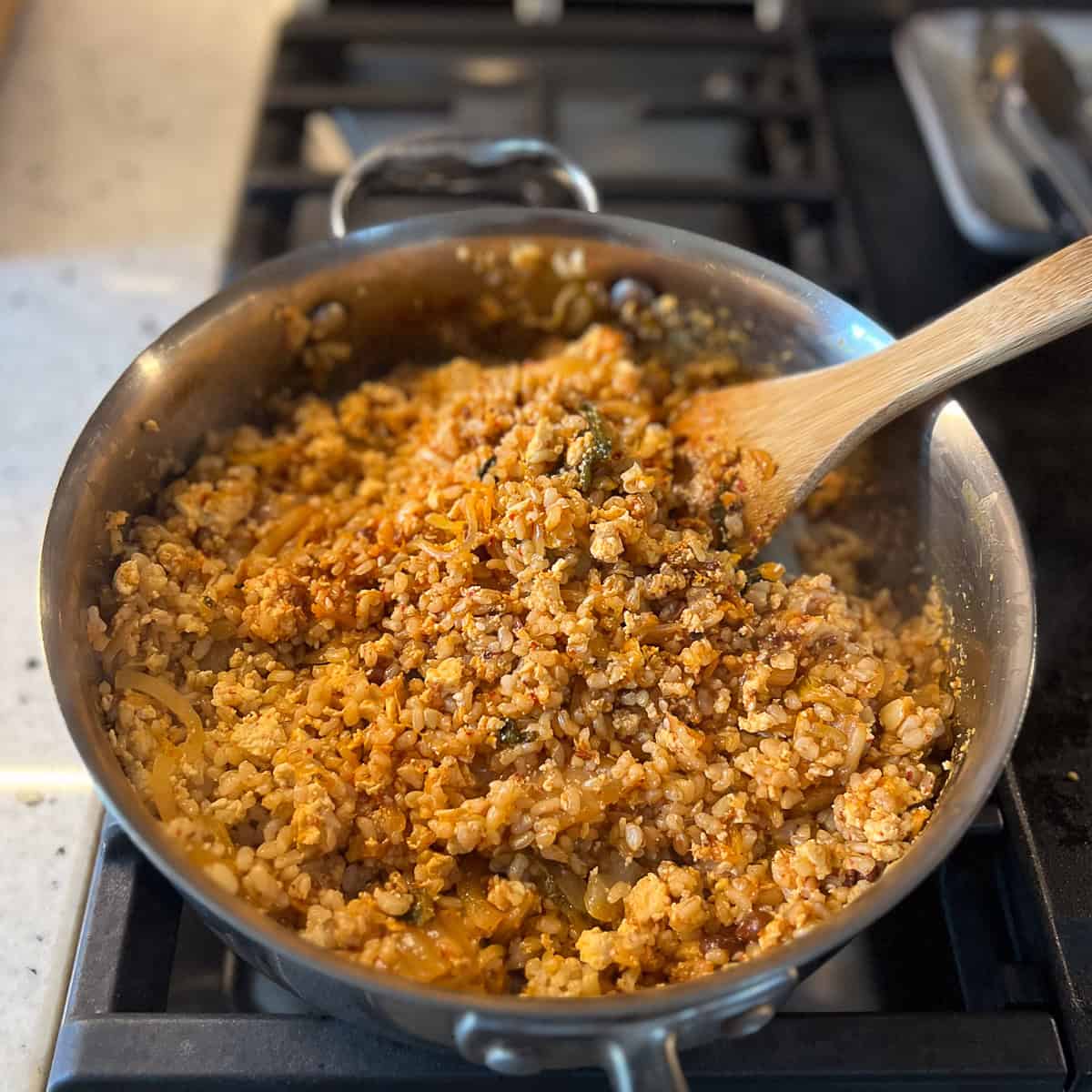 Kimchi fried rice in a pan on the stovetop.