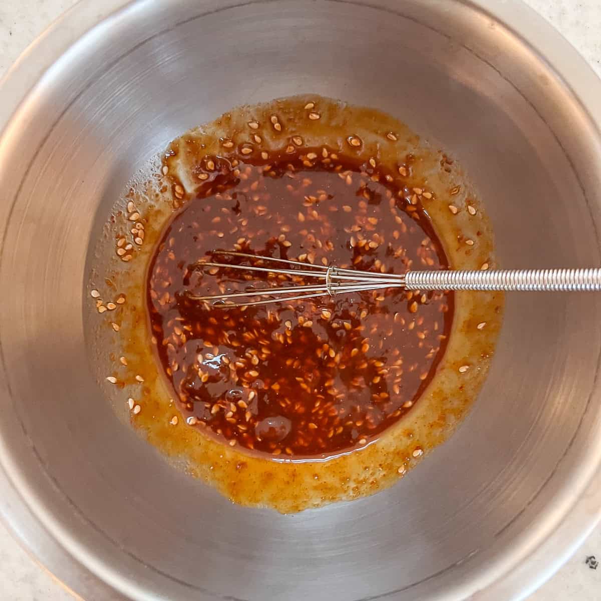 Kimchi fried rice sauce that has been combined in a mixing bowl.