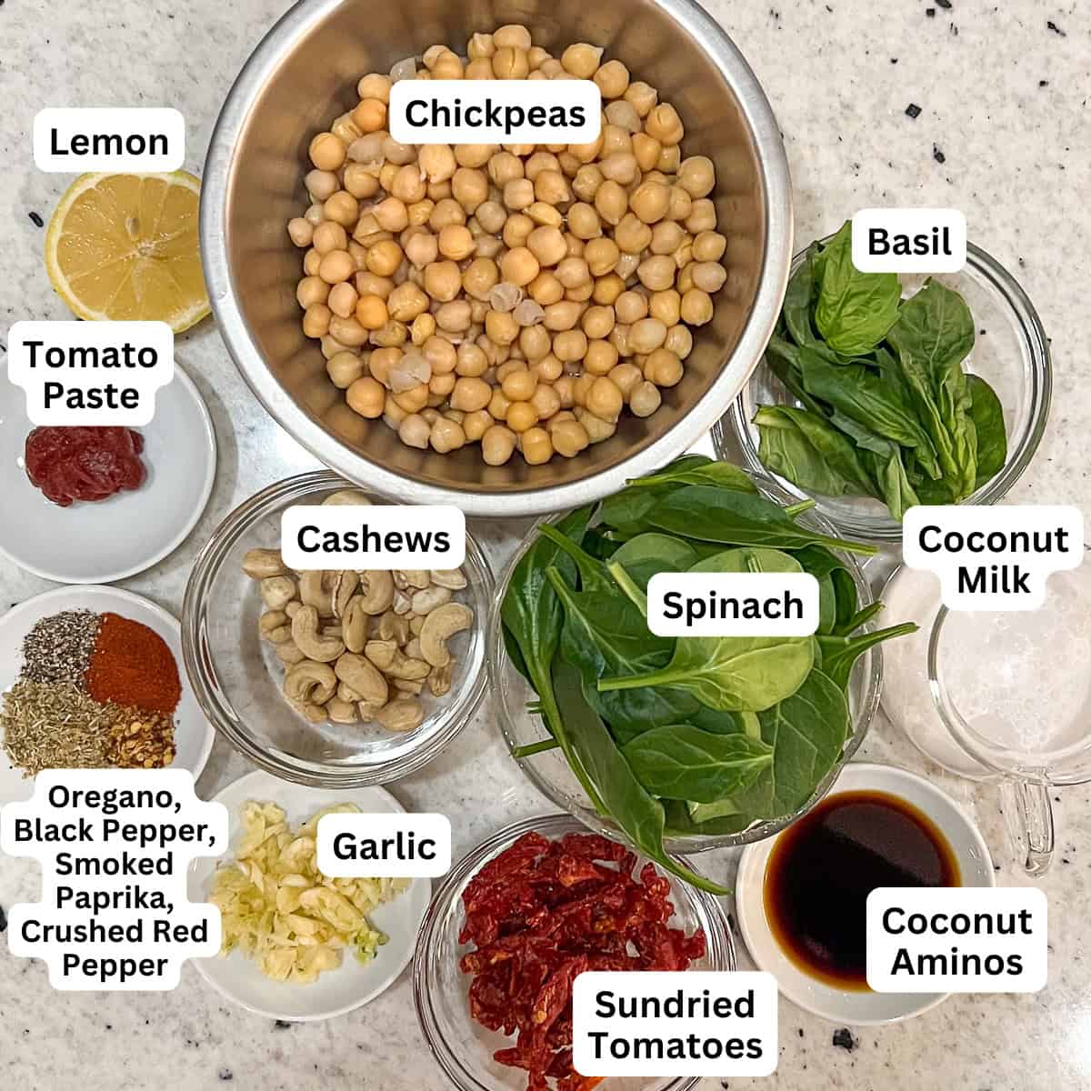 Ingredients for Marry Me Chickpeas: chickpeas, garlic, cashews, lemon, sundried tomatoes, oregano, smoked paprika, black pepper, crushed red pepper, aminos, tomato paste, plain unsweetened coconut milk, spinach and fresh basil.