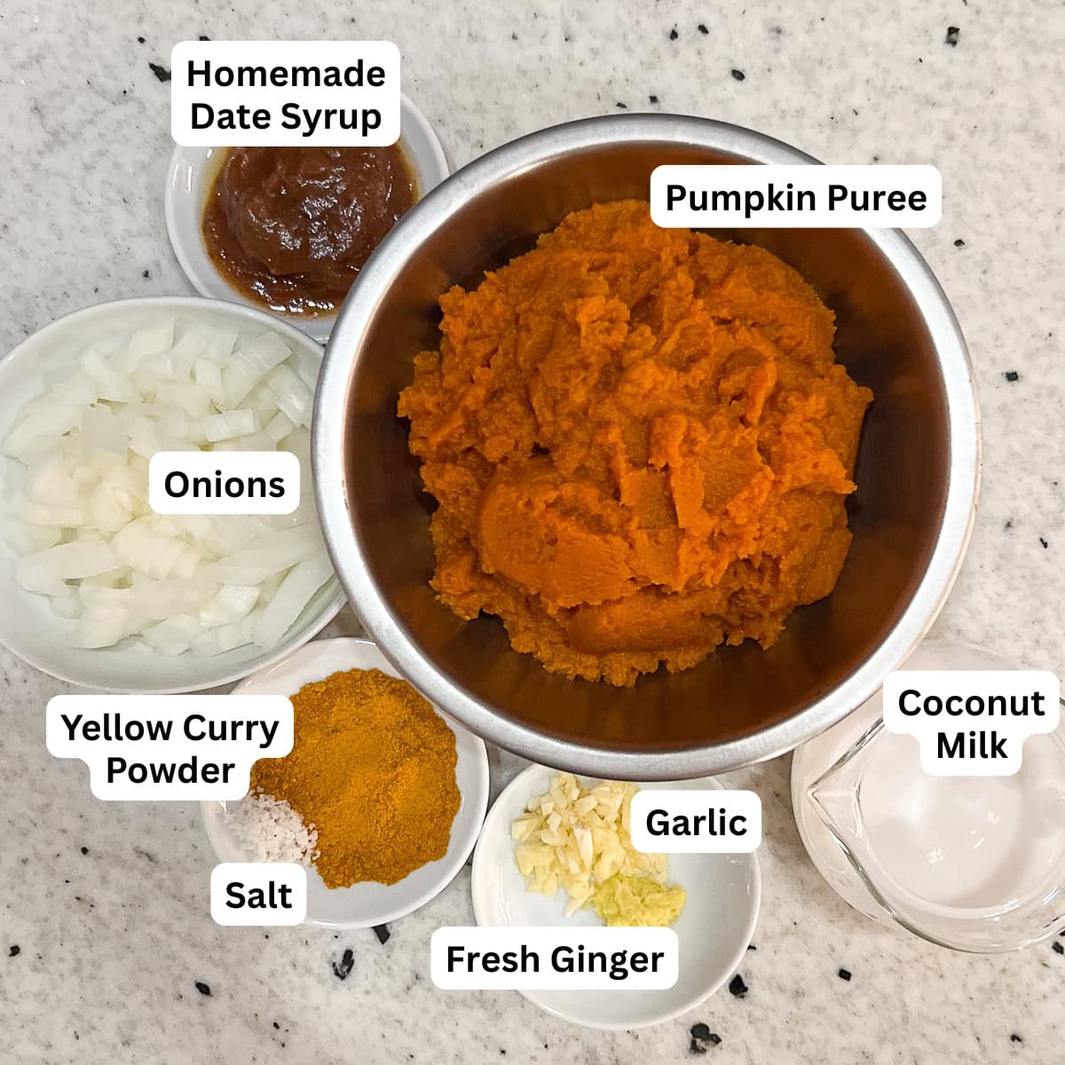 Ingredients for pumpkin curry soup: pumpkin puree, onion, garlic, ginger root, homemade date syrup, curry powder, plain unsweetened coconut milk.