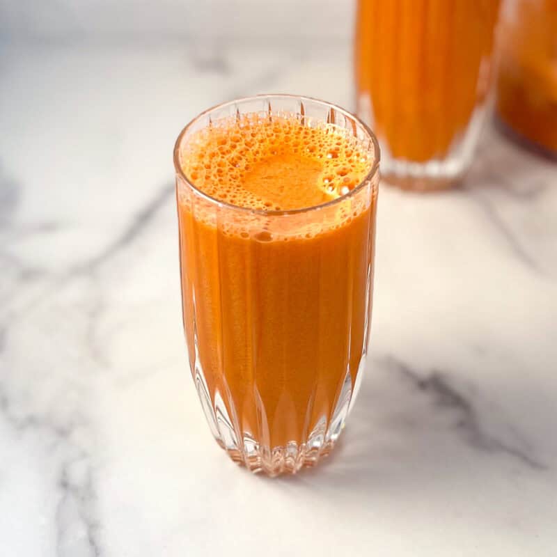 Carrot apple celery juice in a glass.