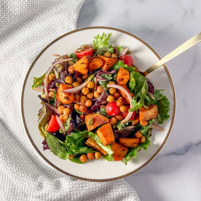 Chickpea sweet potato salad in a bowl with fork.