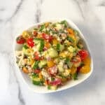 Vegan cucumber tomato and feta salad in a bowl.