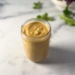 Vegan honey mustard in a mason jar.