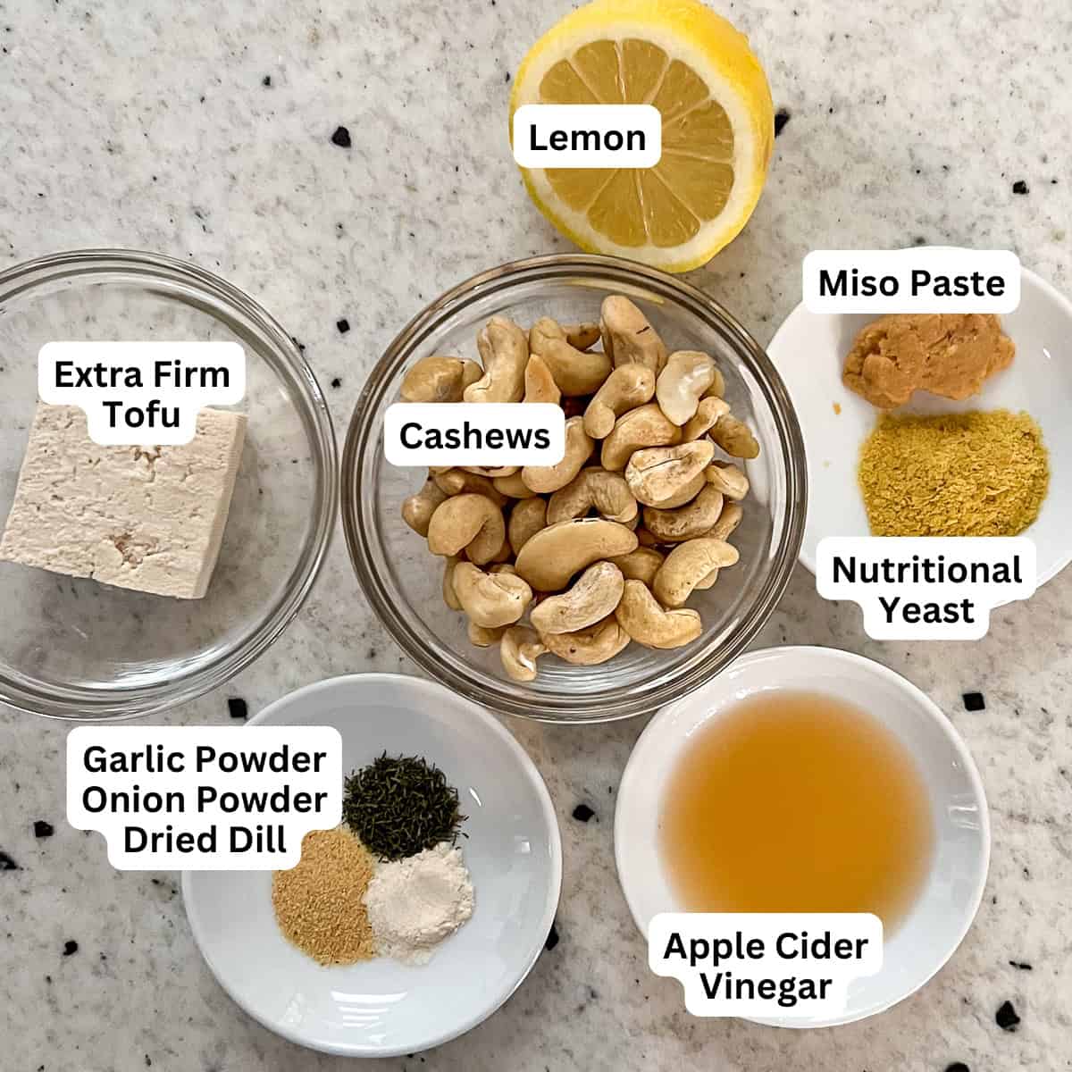 Ingredients for vegan blue cheese dressing: cashews, miso, nutritional yeast, lemon, apple cider vinegar, tofu, and seasonings.