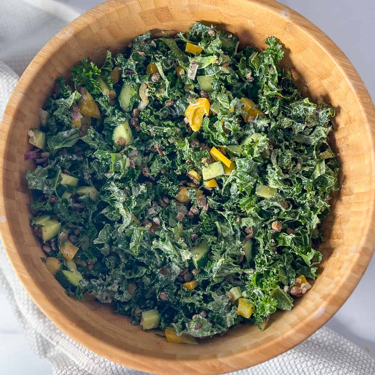 Kale lentil salad in a wooden bowl.