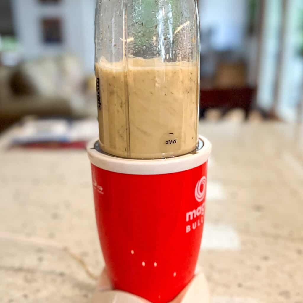 Vegan blue cheese dressing base being blended in a mini blender.