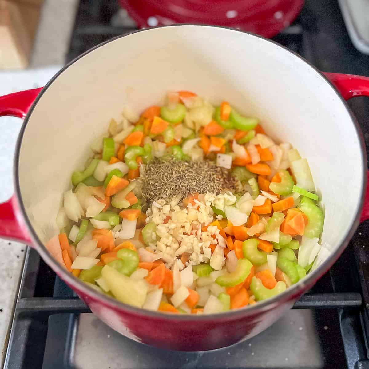 Minced garlic and other seasonings added to the pot with sautéed onions, carrots and celery.