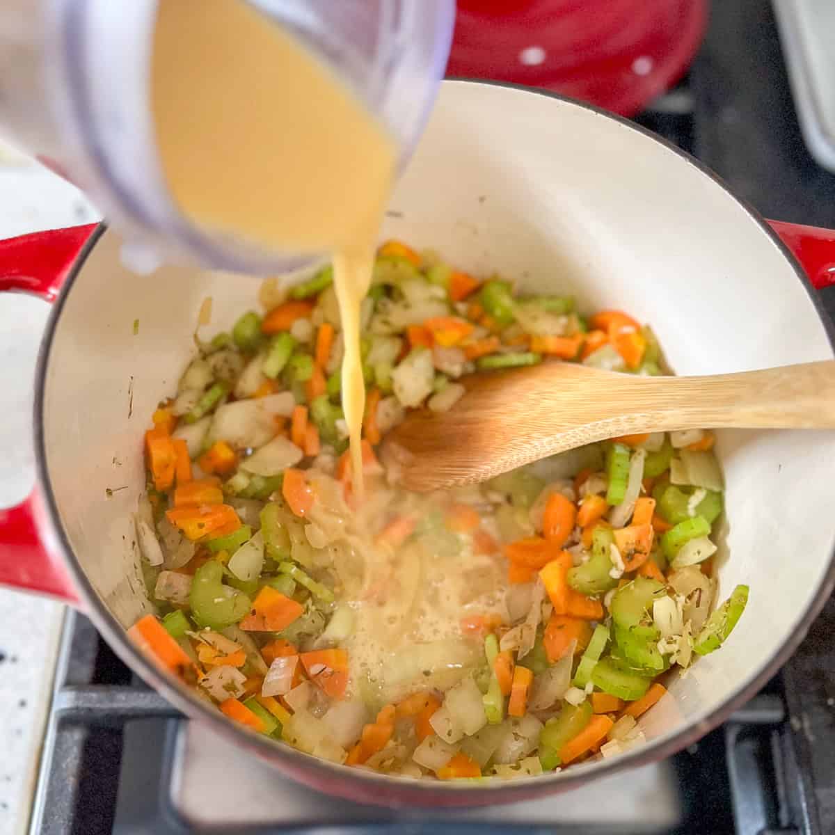 Miso and vegetable broth slurry being added to the pot.