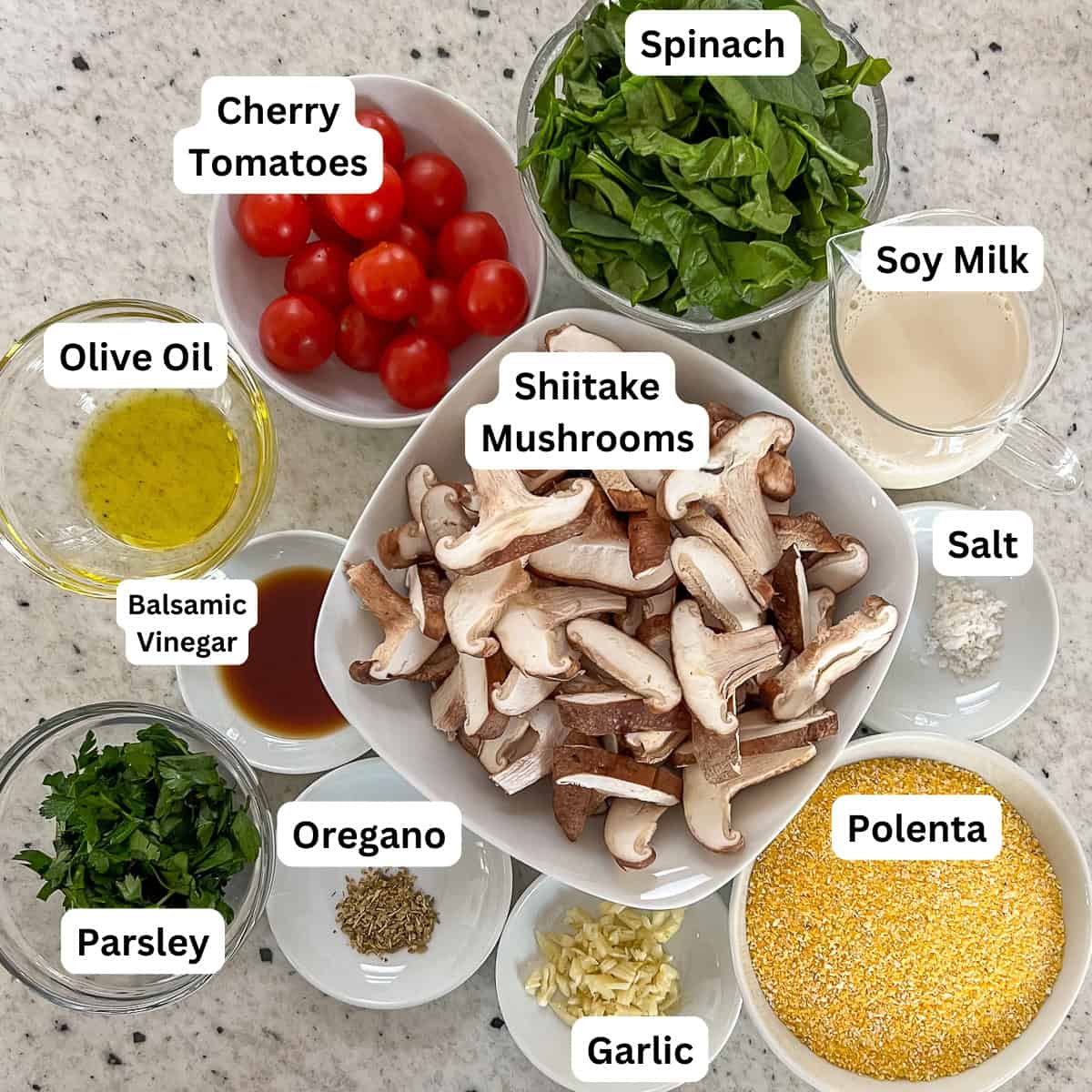 Ingredients for creamy polenta and mushroom: mushrooms, polenta, garlic, salt, oregano, balsamic vinegar, parsley, olive oil, cherry tomatoes, spinach, and plain unsweetened soymilk.