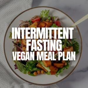 Intermittent Fasting Vegan Meal Plan graphic with a hearty salad faded in the background.