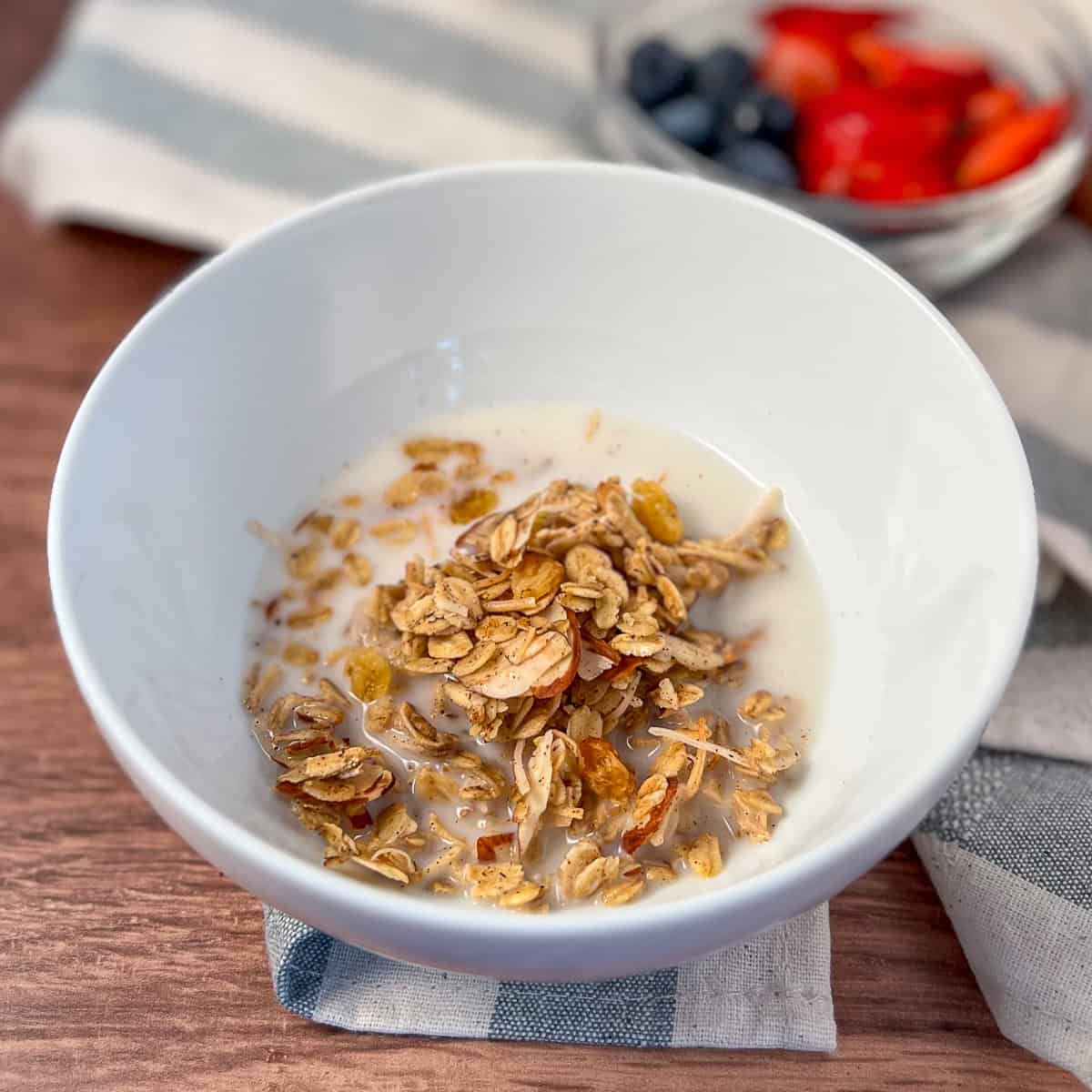 Vanilla almond granola in a bowl with almond milk.