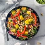 A bowl of chopped veggies and mangos.