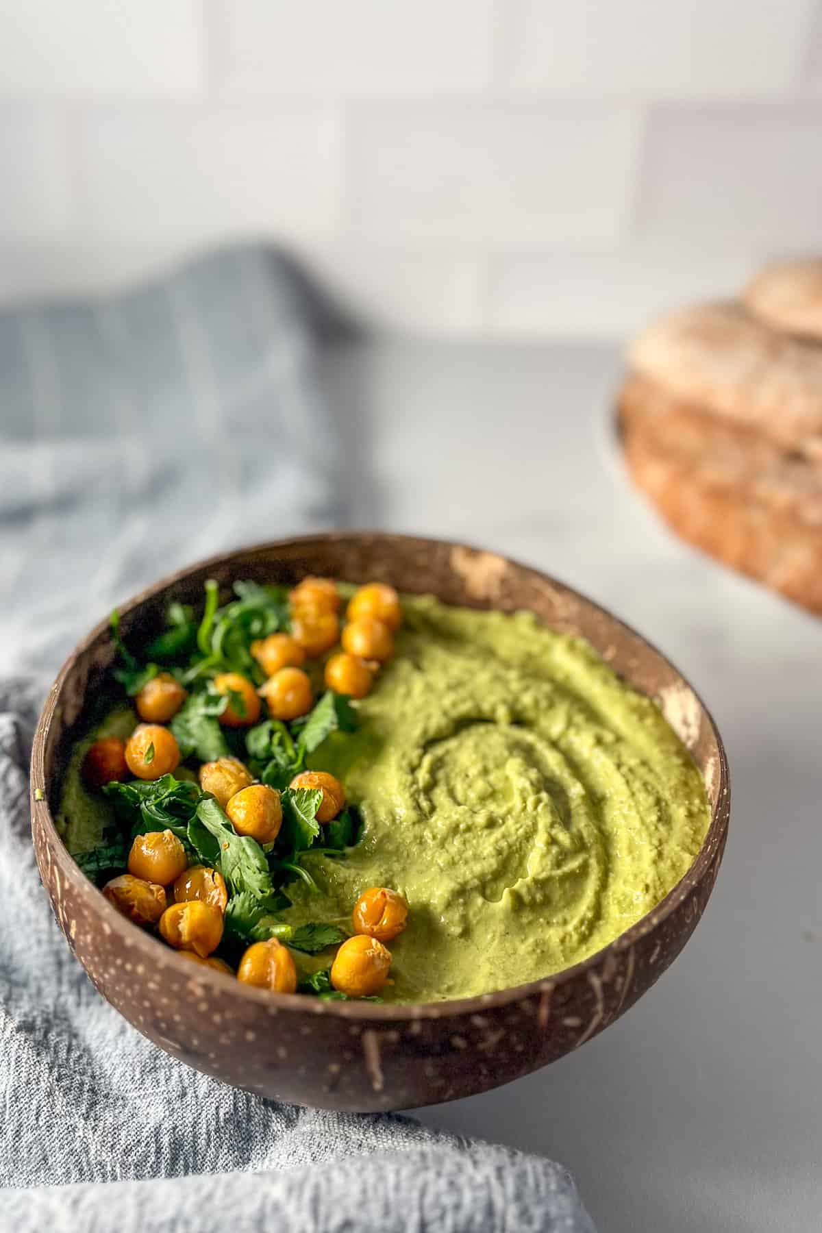 matcha hummus topped with cilantro and roasted chickpeas