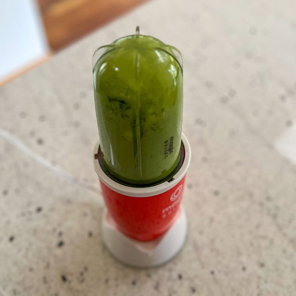 Soy milk and matcha green tea powder blended in a bullet blender.