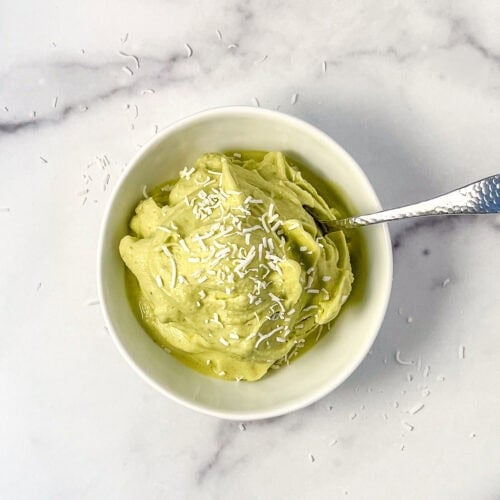 Matcha nice cream in a bowl with a spoon.