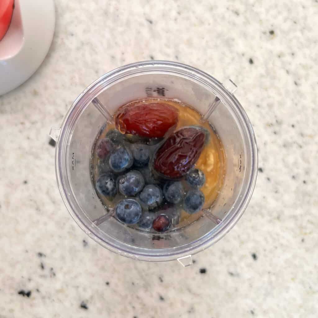 Blueberry vinaigrette ingredients in a mini bullet blender cup before blending.