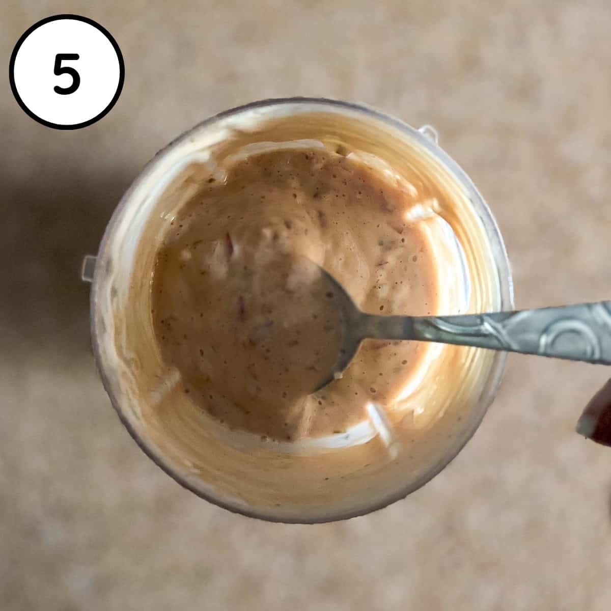 Vegan thousand island dressing being prepared in a blender cup.