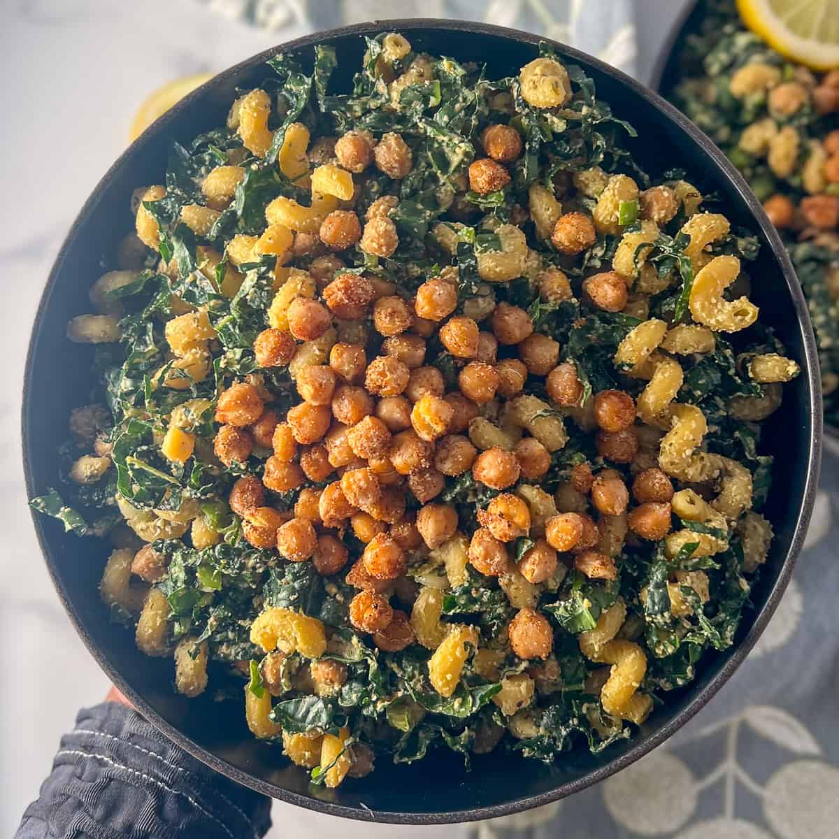 A bowl of kale Caesar pasta salad.