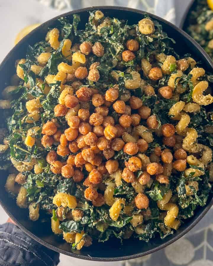 A bowl of kale Caesar pasta salad.