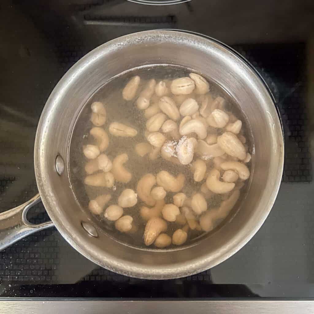 A pot with cashews boiling.
